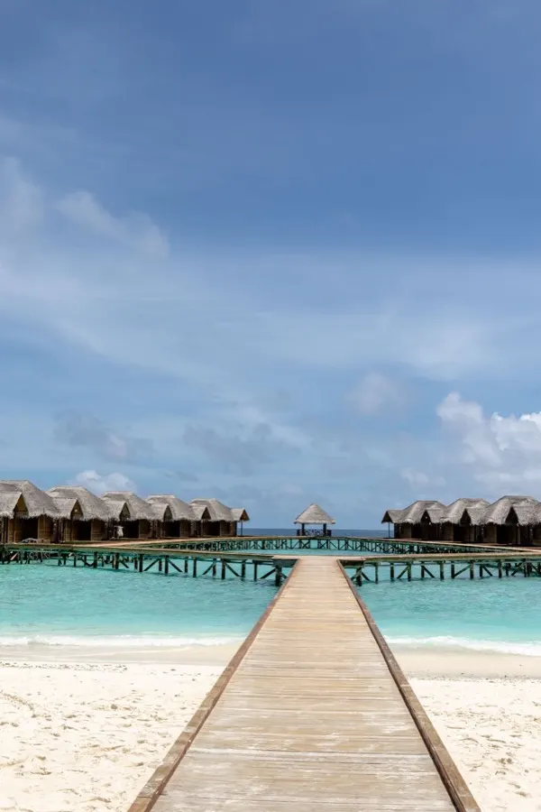 eSIM Dhidhdhoo Maldives - lush local island with traditional Maldivian homes and turquoise atoll lagoon
