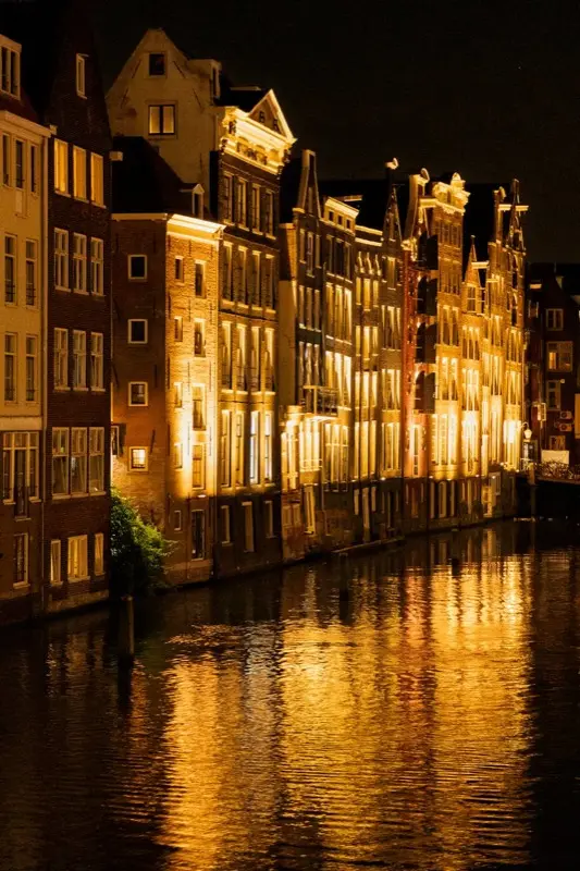 Amsterdam Canal Houses Night Reflection in Amsterdam Netherlands with HelloRoam eSIM