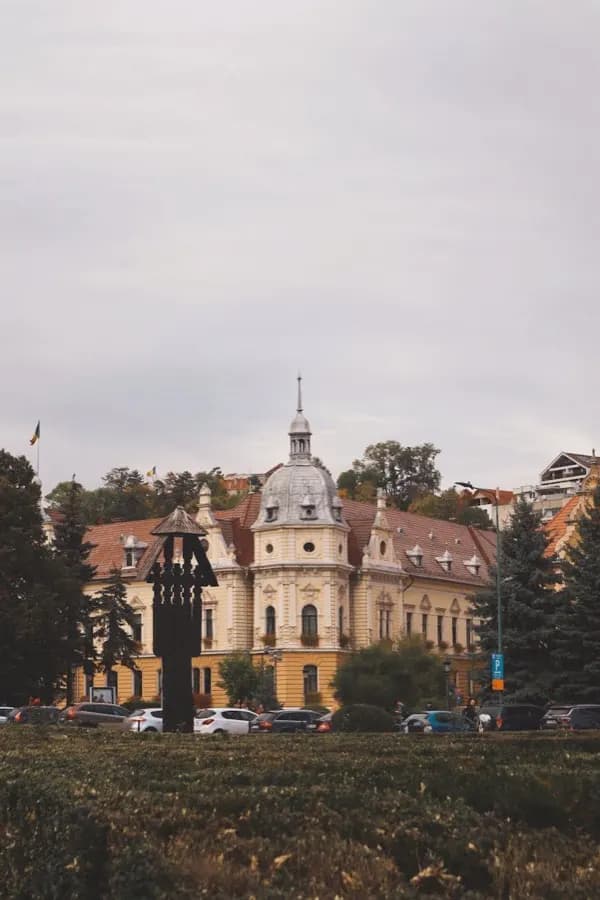 eSIM Brasov Romania - medieval old town under the Hollywood-style Brasov sign on the forested Carpathian hillside