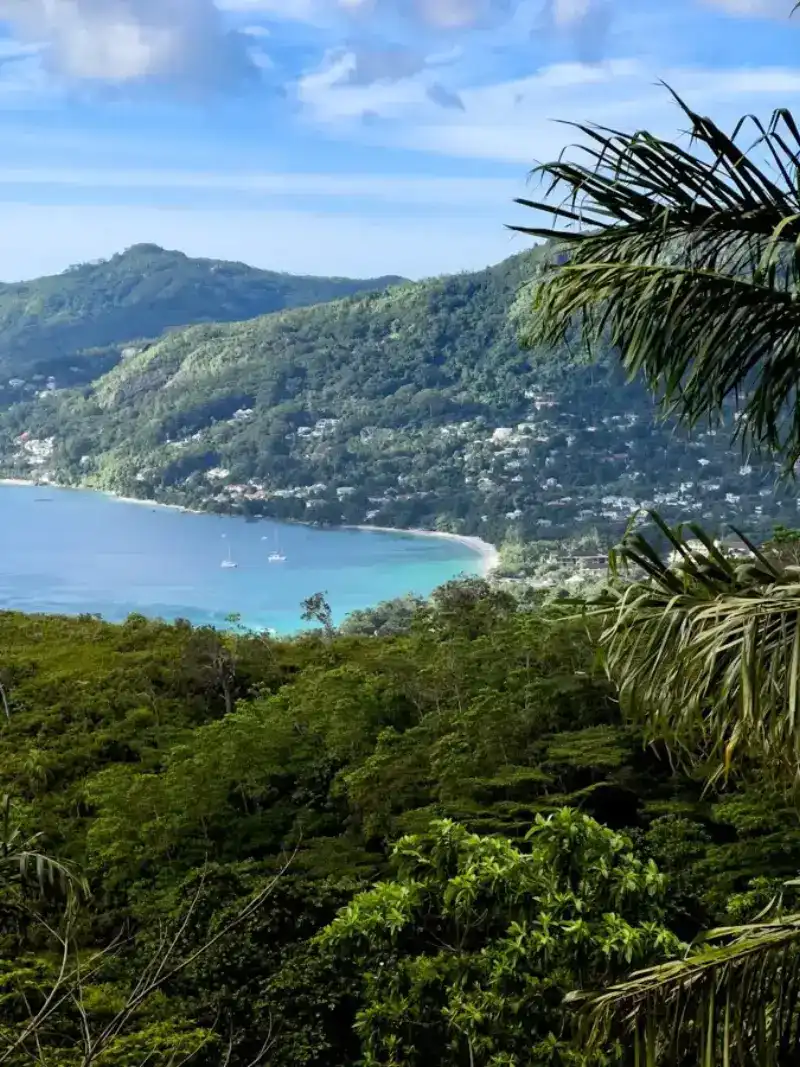 eSIM Mahe Seychelles - white sand Beau Vallon beach with crystal clear water and granite boulders at sunset
