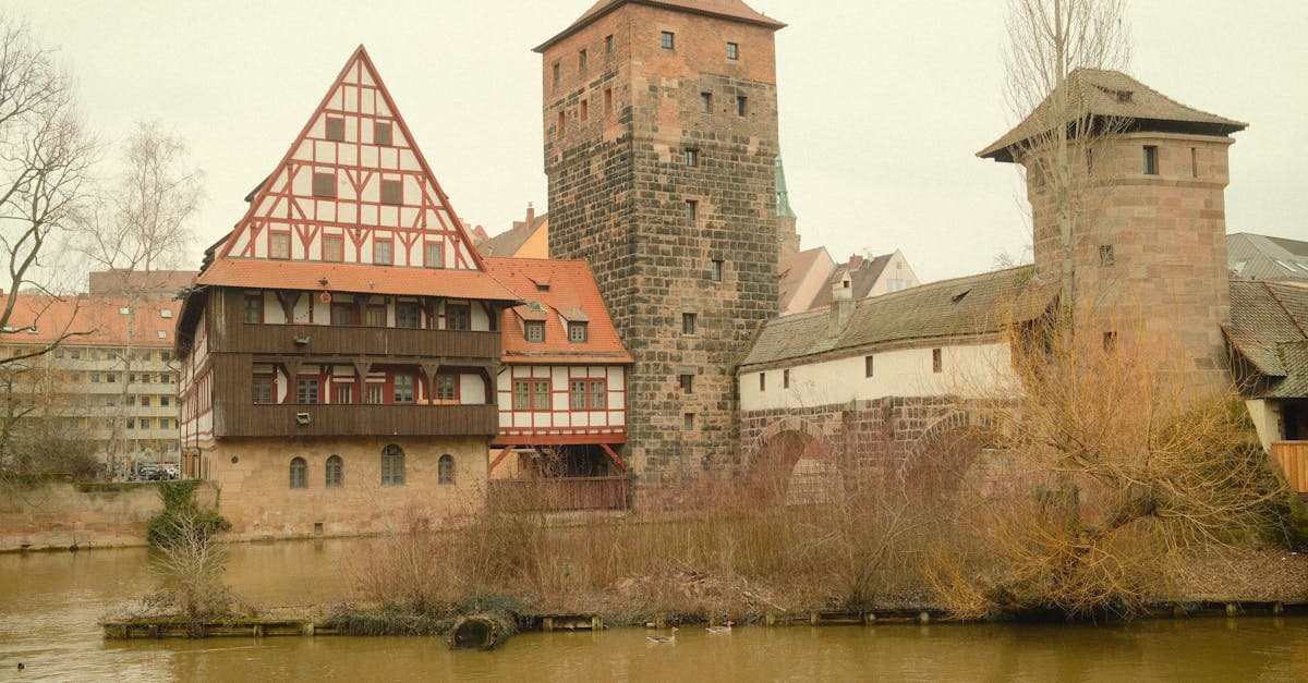 Scenic view of medieval architecture in Nuremberg, Germany by the water on an overcast day.