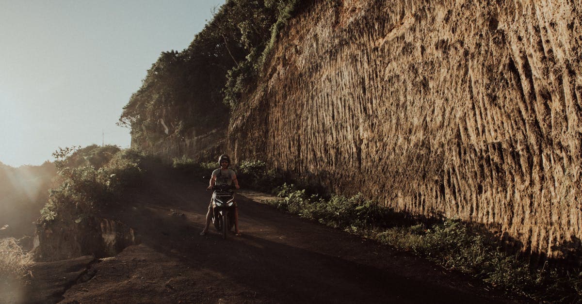 Traveller riding a scooter along a Bali dirt road at sunset, needing reliable mobile data