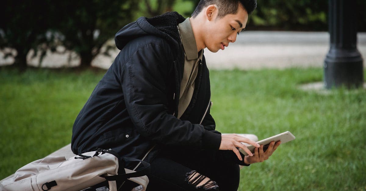 Young traveller using a tablet outdoors in Japan, deciding if free public wifi is reliable enough