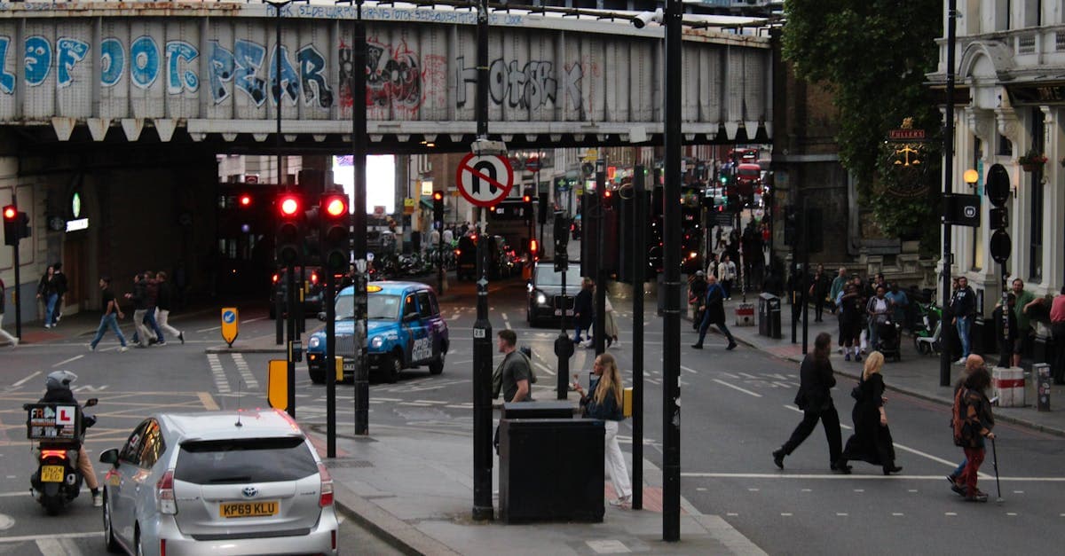 Busy London street with pedestrians, traffic, and a graffiti bridge showing UK networks behind the best eSIM plans