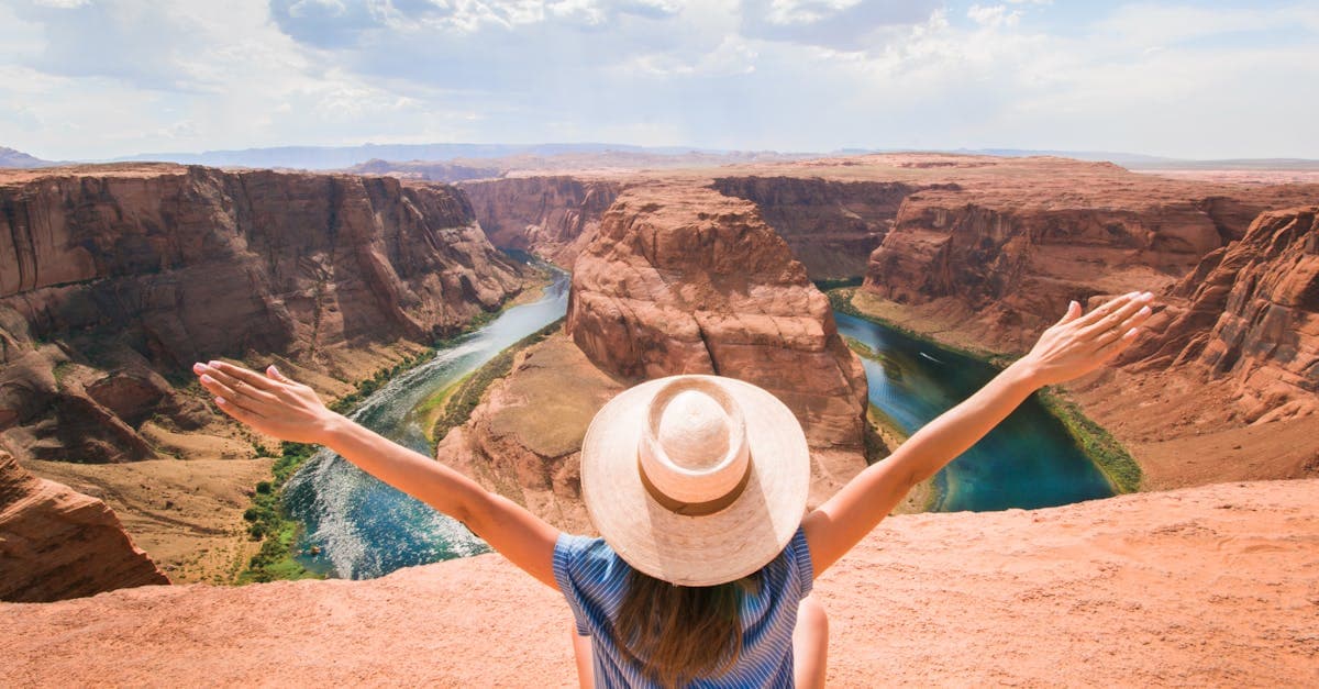 Woman enjoying scenic Horseshoe Bend canyon view representing hidden cheap vacation destination gems