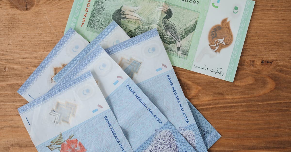 Malaysian Ringgit banknotes fanned on a wooden surface, a key currency for backpacking Southeast Asia