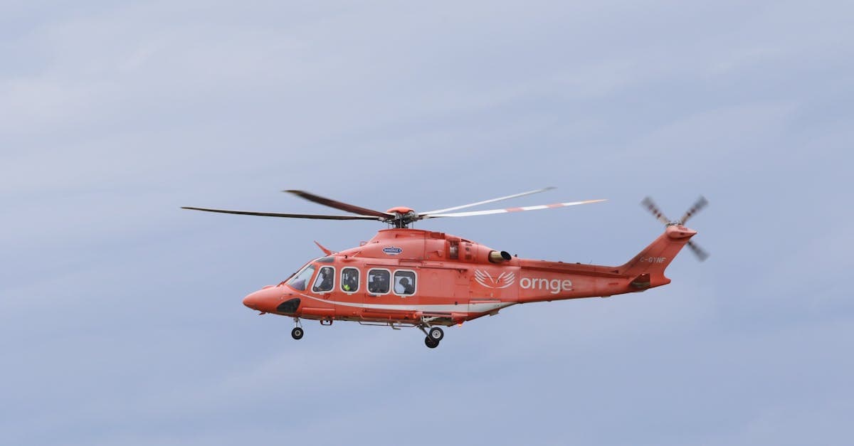 Orange rescue helicopter airlifting a casualty, demonstrating emergency evacuation cover within backpacker insurance policies