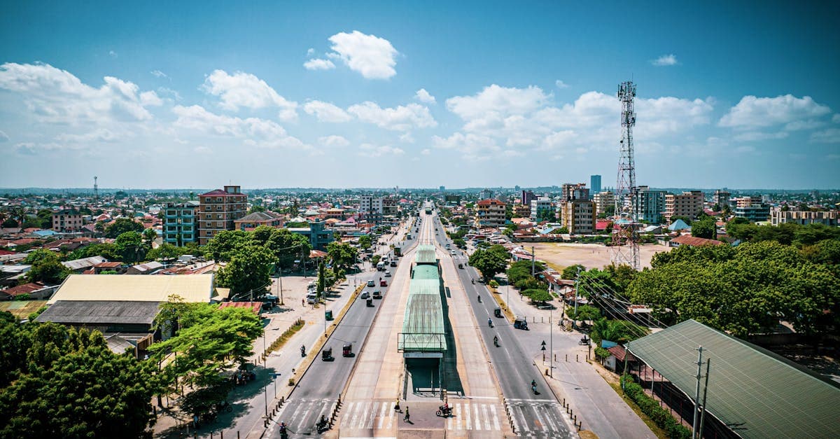 Vibrant aerial view of a main road in Dar es Salaam, Tanzania, with bustling urban landscape.