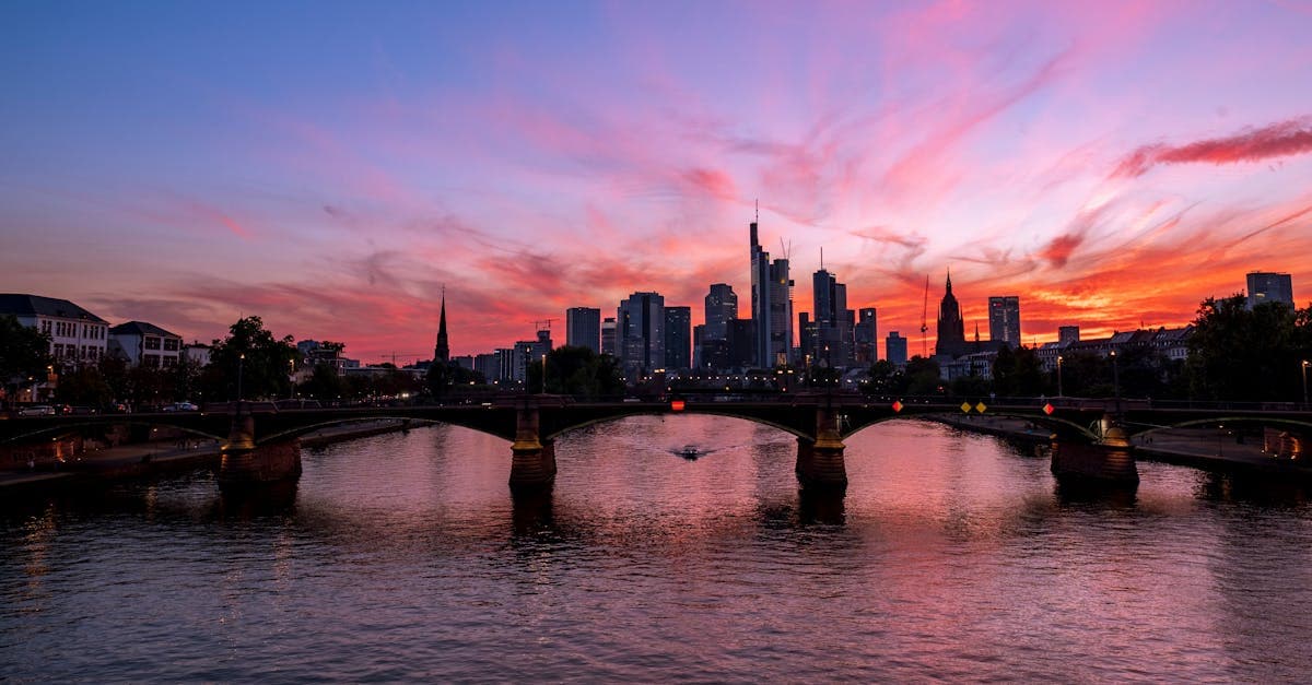 Stunning sunset view over the river in Frankfurt, showcasing its dramatic skyline and reflections.