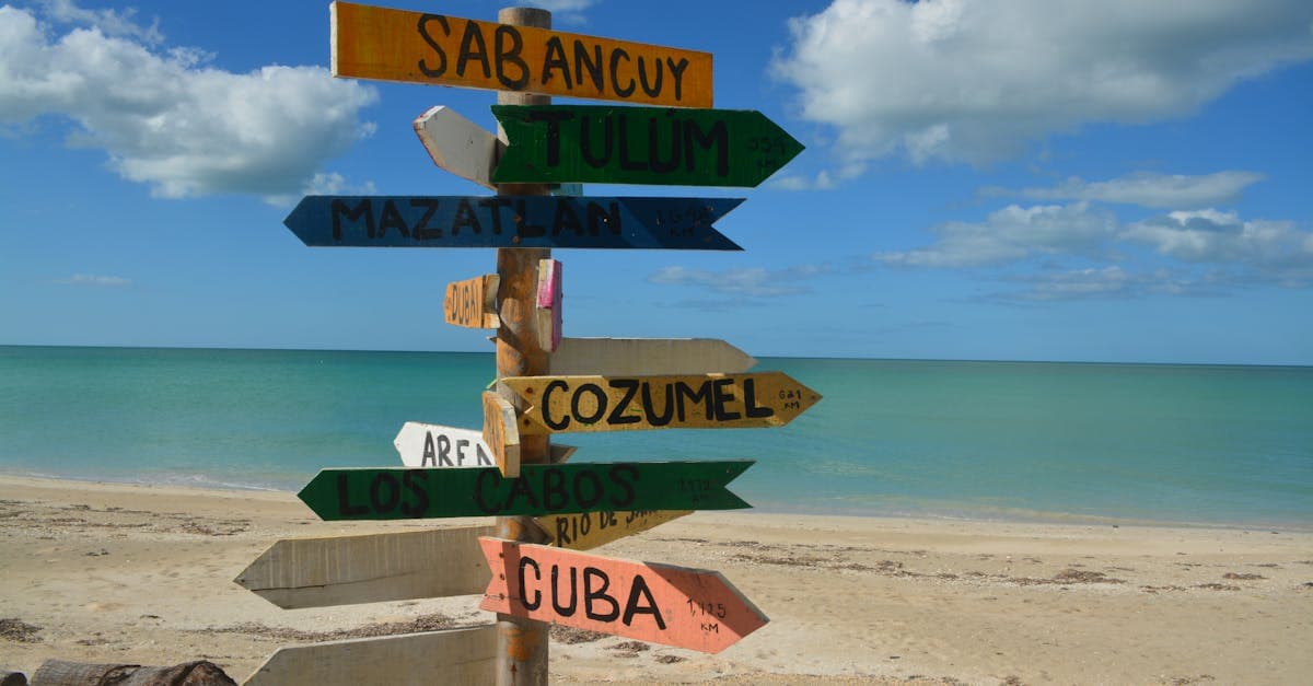 Colorful beach signpost indicating popular destinations for budget travelers seeking cheap vacation spots