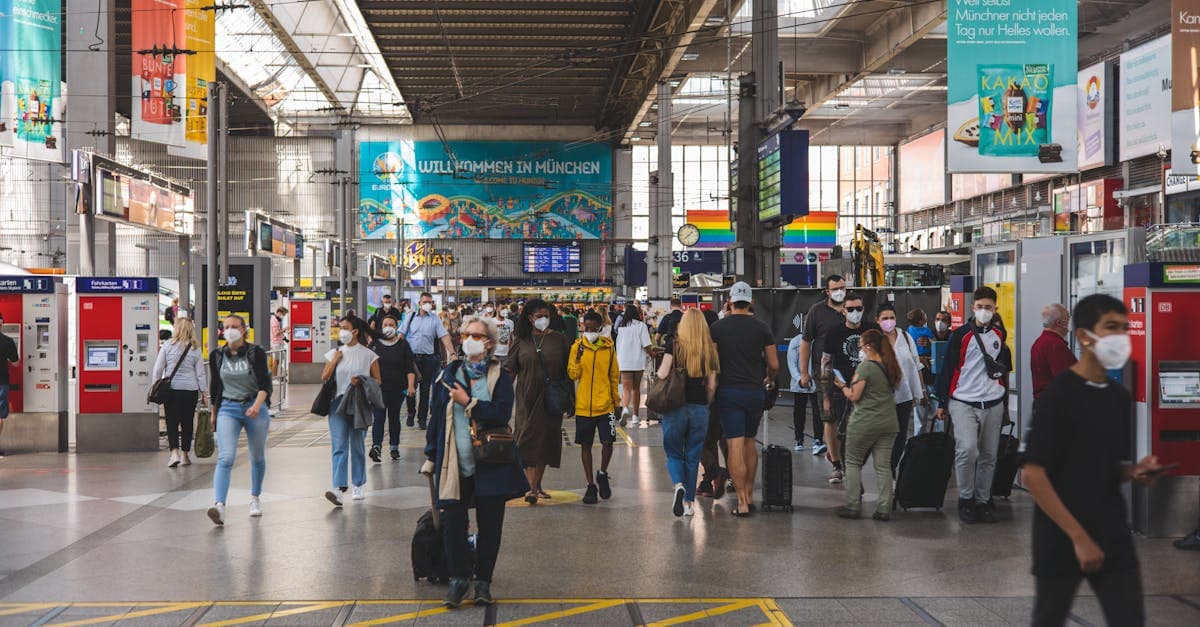 Belebte Szene am München Hauptbahnhof zeigt Reisende mit Handgepäck und Koffern im Überblick.