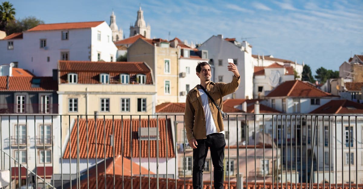 Solo traveler taking a selfie among Lisbon's iconic architecture while staying connected during a Europe trip
