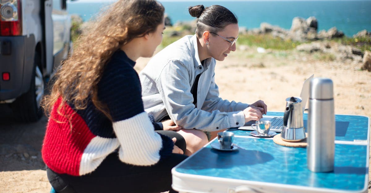 Remote workers collaborating outdoors by Portuguese coast illustrating digital travel eSIM visa portugal lifestyle benefits.