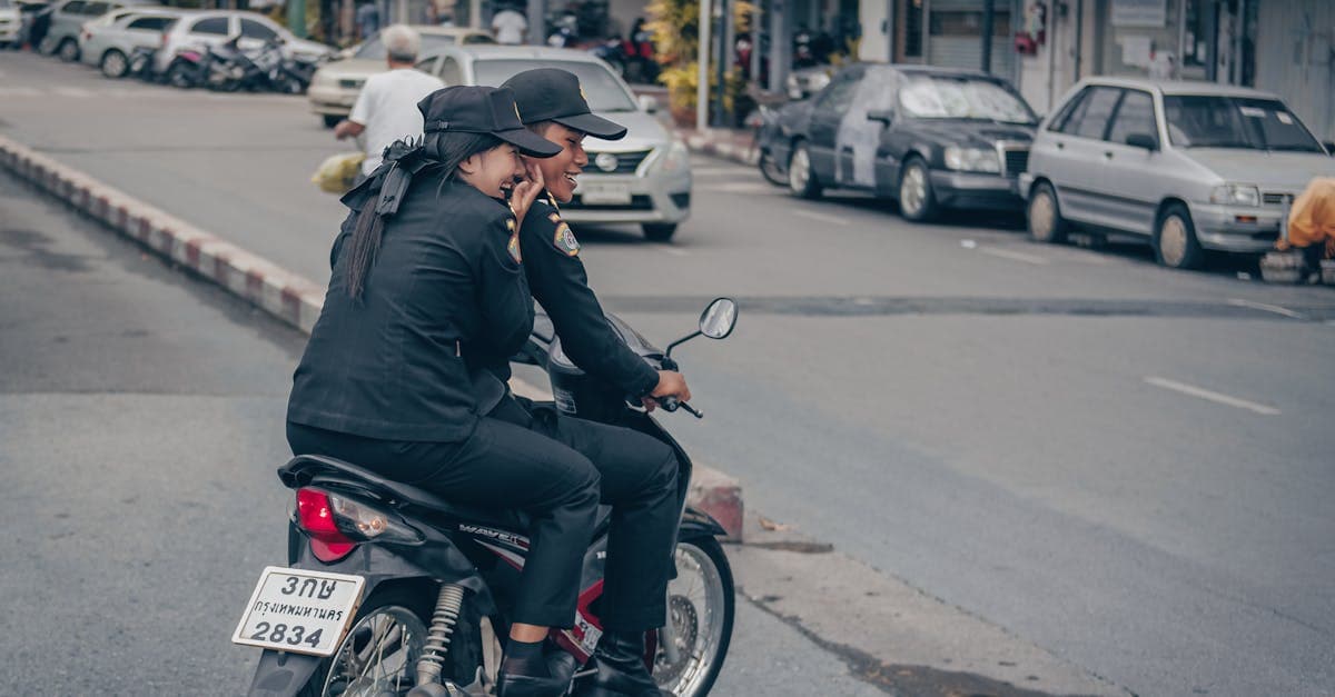 Two police officers on a motorcycle patrolling busy Bangkok streets, enforcing Thailand's strict drug laws and taboos