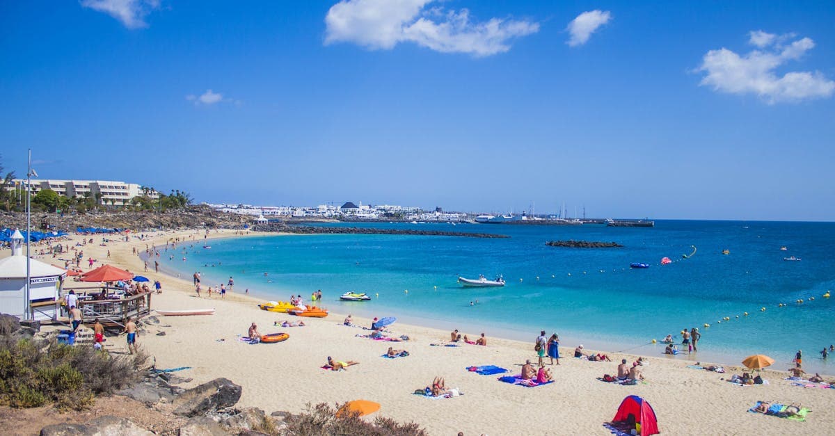 Families relaxing on the golden sands of Playa Blanca during the best season to visit Lanzarote from Ireland