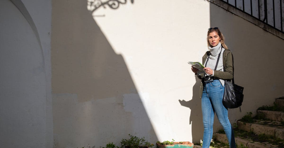 Woman navigating a European city street with a map, checking mobile coverage while travelling abroad