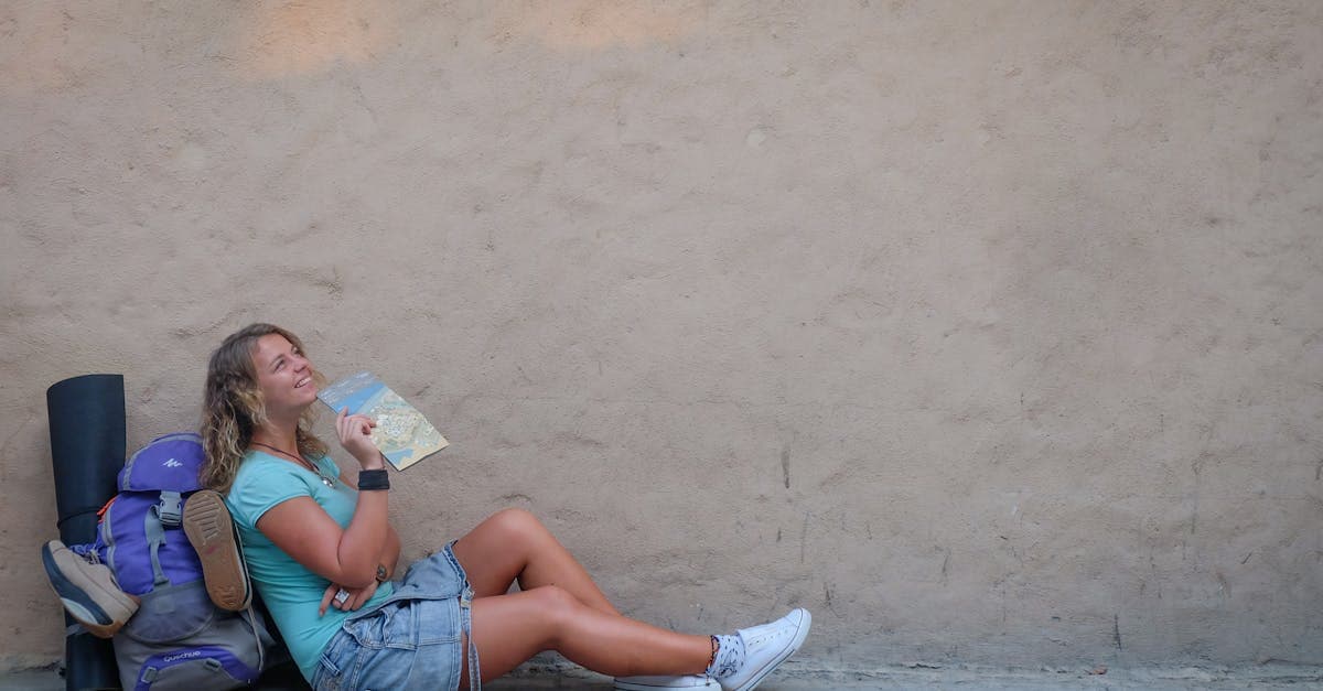 Smiling female traveler with a map enjoying her solo trip europe adventure on a sunny day