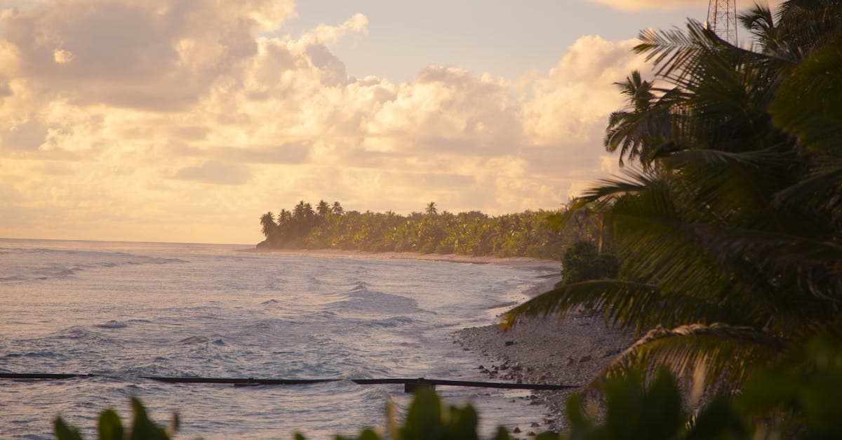 Tropical sunset over a Cook Islands beach, showing why peak season is the best time to visit Rarotonga