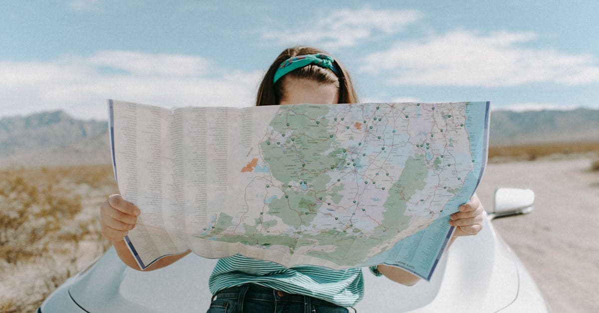 Woman consulting a map in the California desert, demonstrating practical solo travel safety tips.
