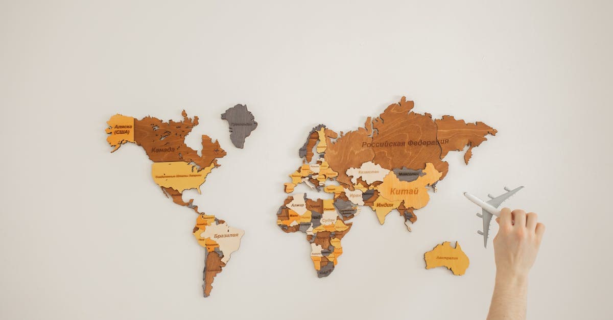 Miniature aircraft placed over a decorative world map, symbolising booking cheap international flights from India