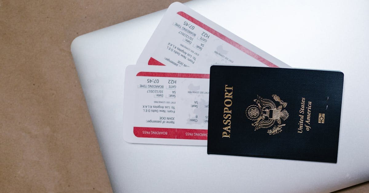Passport and boarding passes on a laptop showing ferry and booking deadlines for a New Zealand travel itinerary.