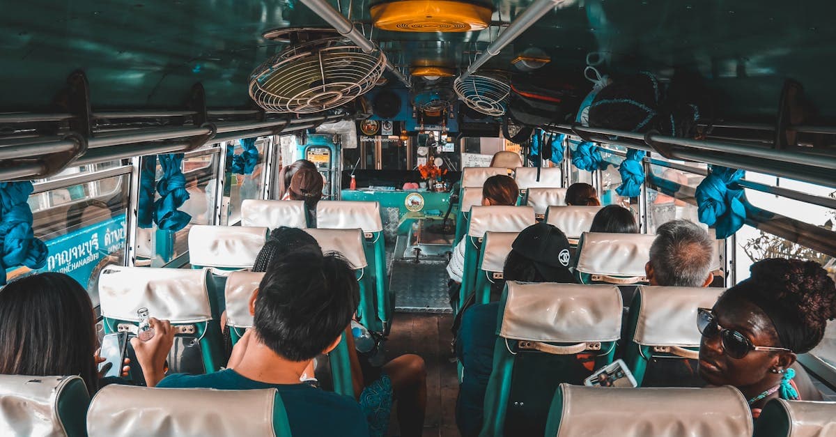 Tourists riding a local bus through Kanchanaburi — essential transport advice from every thailand travel guide