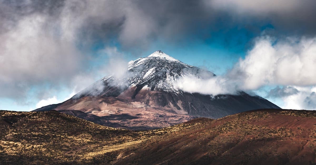 Snow-capped Mount Teide towering above clouds, a landmark to seek during the best time to visit Tenerife