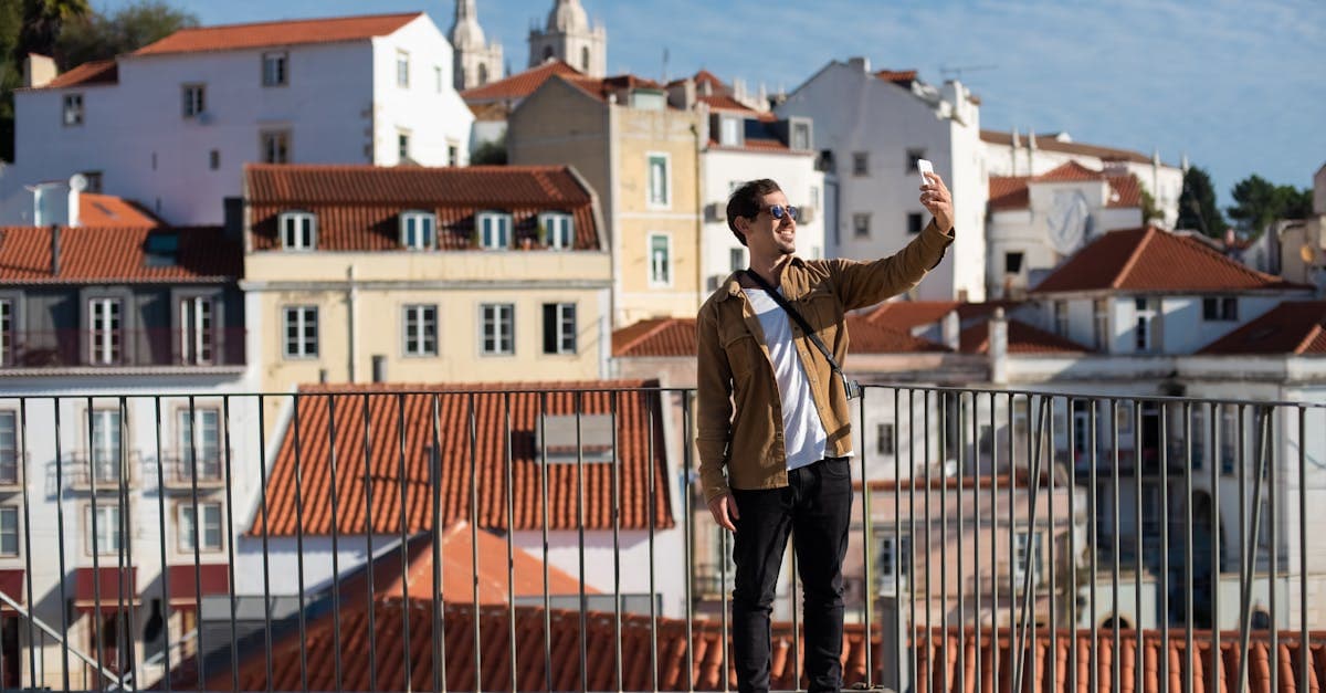 Happy traveller taking a selfie in Alfama Lisbon, celebrating approval of their digital travel eSIM visa portugal