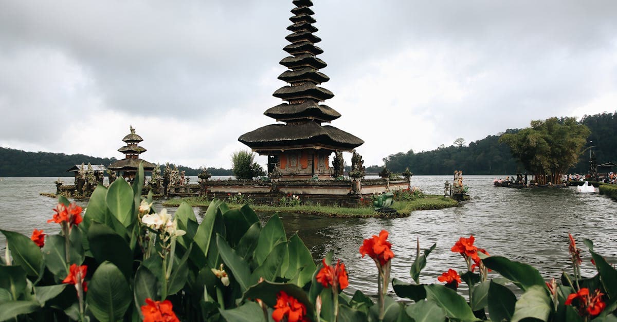 Ulun Danu Beratan Temple with vibrant foreground flowers, a peaceful and safe stop for New Zealand tourists