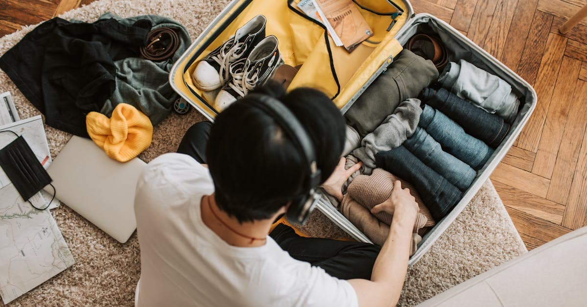 Overhead view of a traveller packing a suitcase while checking travel eSIM options for Ireland