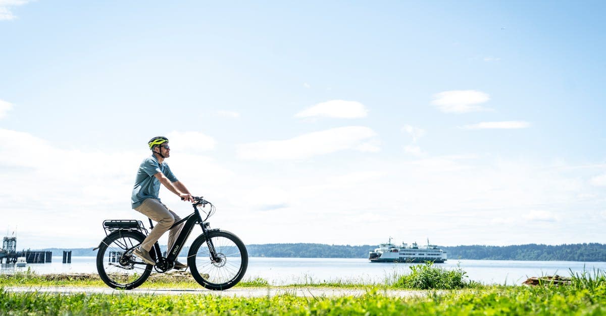 Man cycling a waterfront on a bright day, highlighting budget travel eSIM top picks for UK travelers
