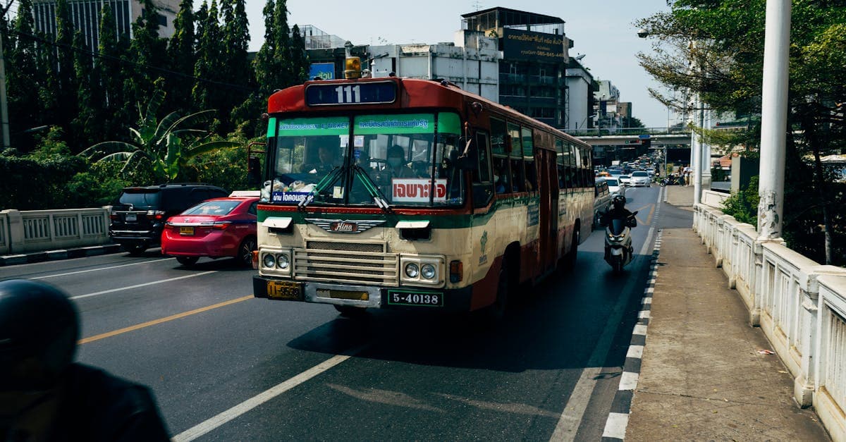 Busy Bangkok street with public buses and motorbikes highlighting real risks when asking is thailand safe