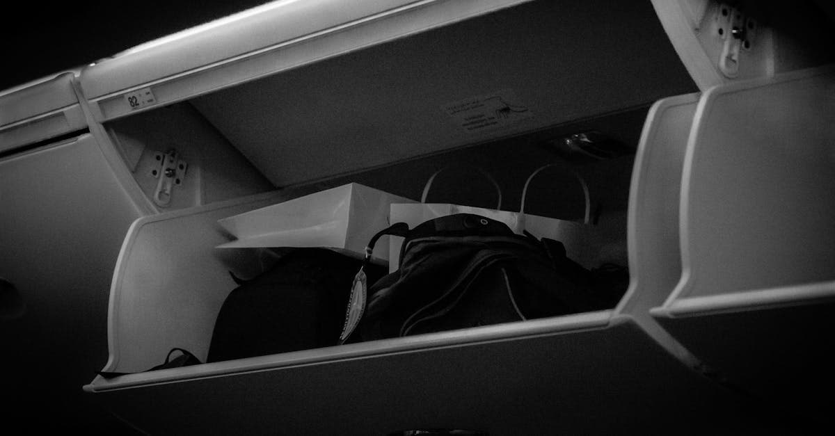 Airplane overhead compartment filled with carry-on bags, showing the 7 kg cabin luggage limit on Indian domestic flights.