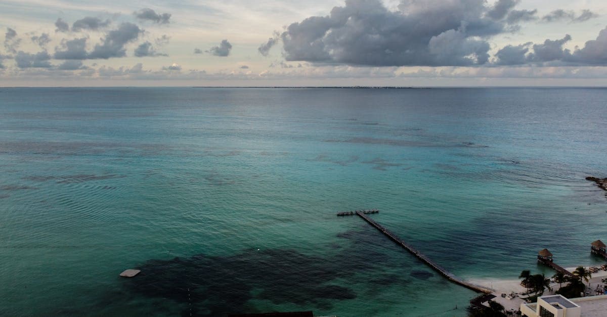 Drone shot of a Caribbean Sea pier in Cancún, Mexico, illustrating the city's current safety threat level