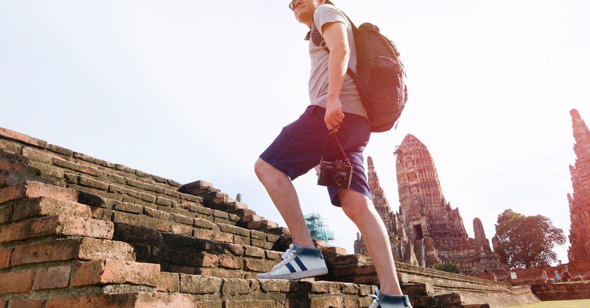 NZ backpacker ascending ancient brick temple steps, one of the unmissable highlights of backpacking Southeast Asia