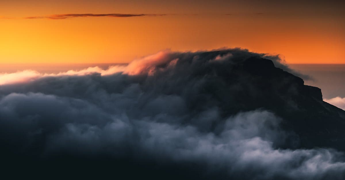 Tenerife mountain peak at sunset with low cloud, capturing the island's beauty from summer through December
