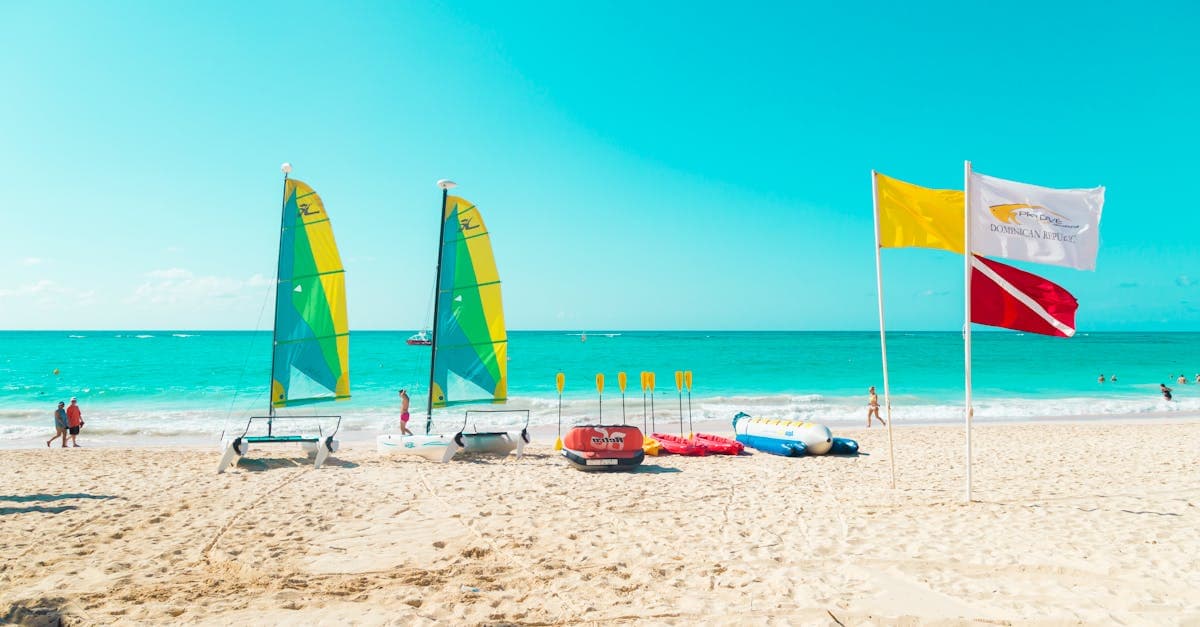 Journée ensoleillée sur la plage de Punta Cana avec voiliers colorés, what to do in punta cana