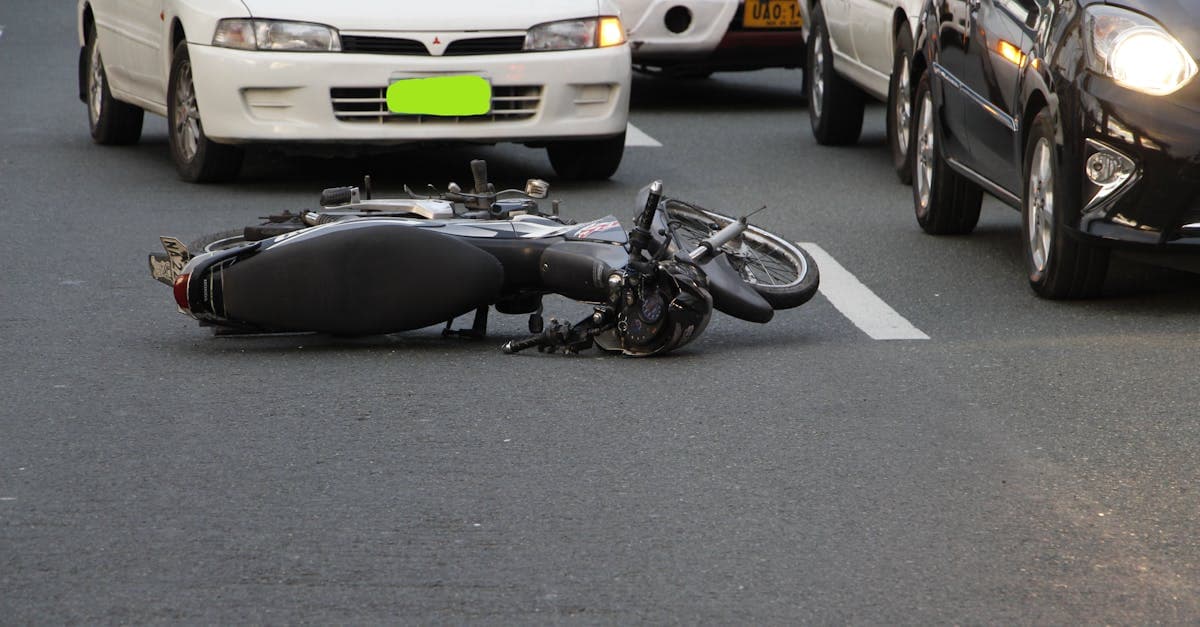 Motorcycle lying on a busy city road after a traffic accident, a leading danger for tourists in Thailand.
