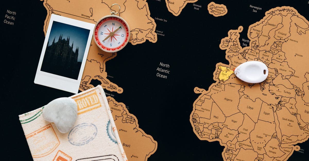 Travel planning flat lay with map, compass, and polaroids for exploring cheapest countries to visit by region