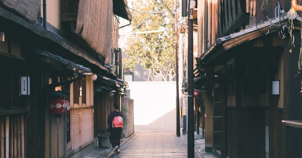 Narrow sun-dappled alley in Gion, Kyoto, lined with traditional machiya architecture — a classic solo travel Japan stop