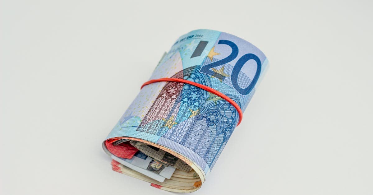 Rolled euro banknotes showing the currency South Africans need for budget travel europe trips