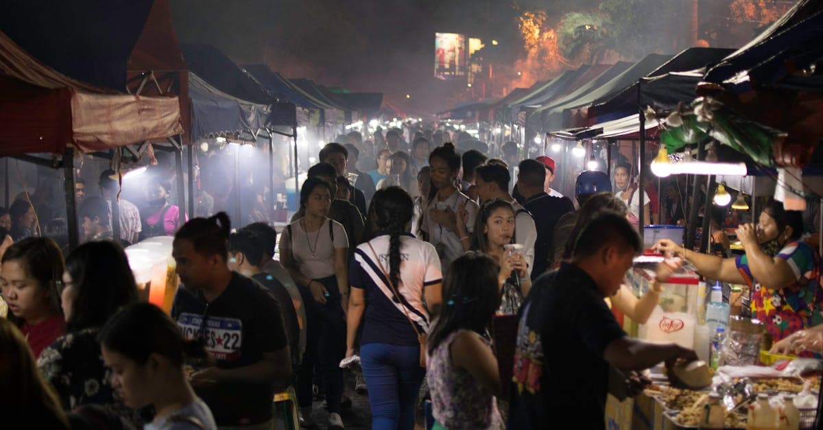 Crowded evening hawker centre food stalls packed with locals exploring what to eat in Singapore