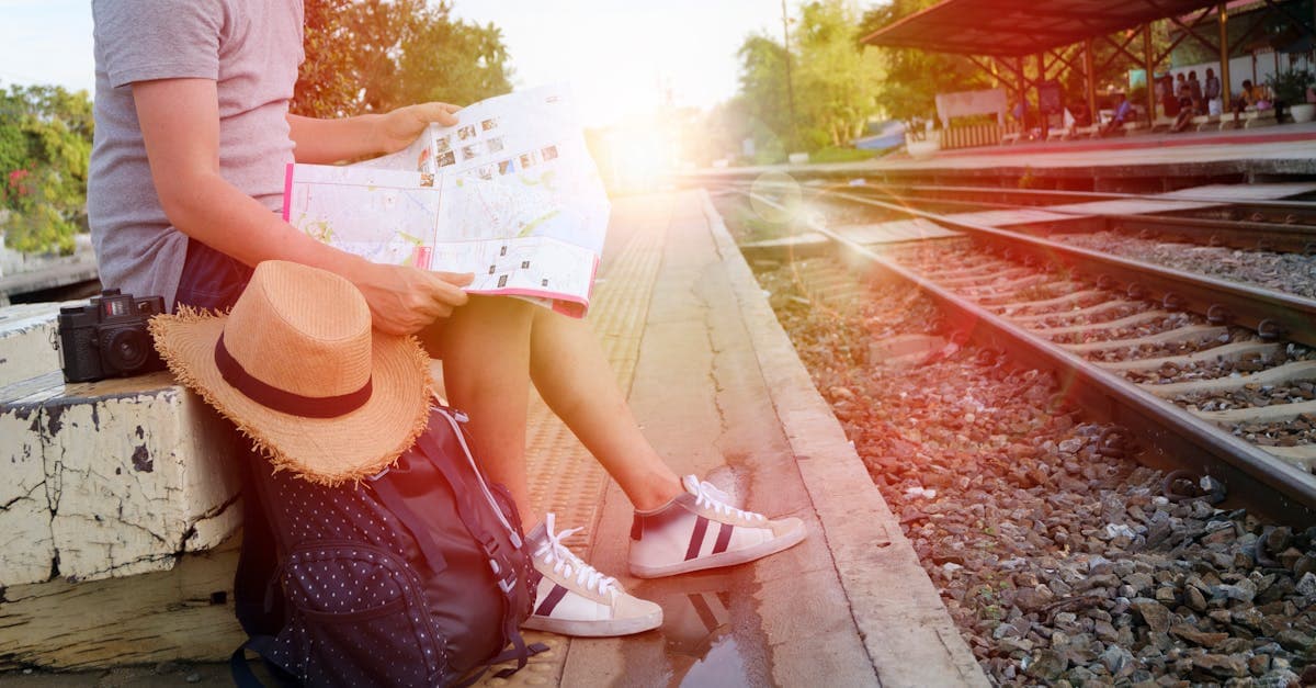 First-time solo traveller reading a map at an Indian railway platform, discovering top solo travel destinations