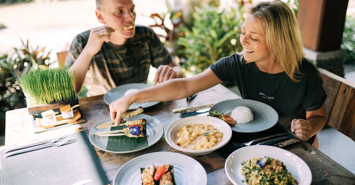 South African couple sampling must-try Balinese dishes outdoors, discovering what to eat in Bali together