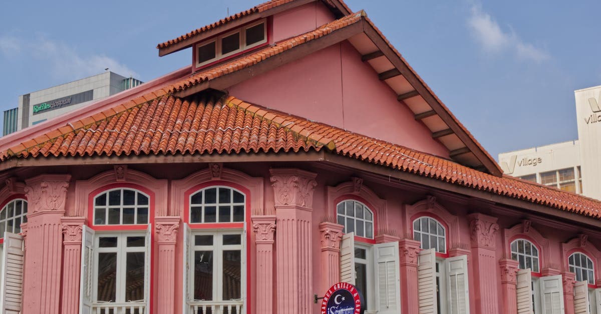 Pink colonial-style heritage building in Singapore where hawker stalls serve traditional local dishes