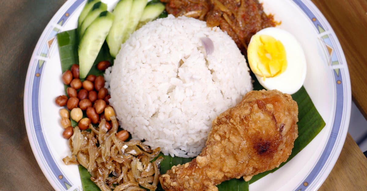 Colourful plate of Nasi Lemak with sambal and fried chicken, an essential Malay dish in what to eat in Singapore