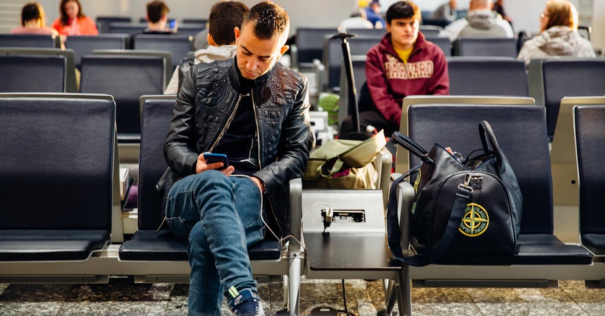 Travellers on smartphones at an airport lounge, staying connected during the best time to visit Europe