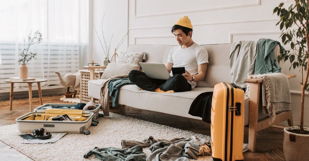 Remote worker surrounded by luggage budgeting for the high cost of living in Singapore