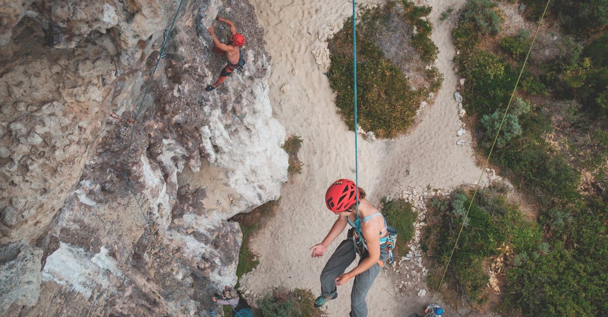 Rock climbers scaling a cliff face, showing activities covered under backpacker insurance but not standard travel policies