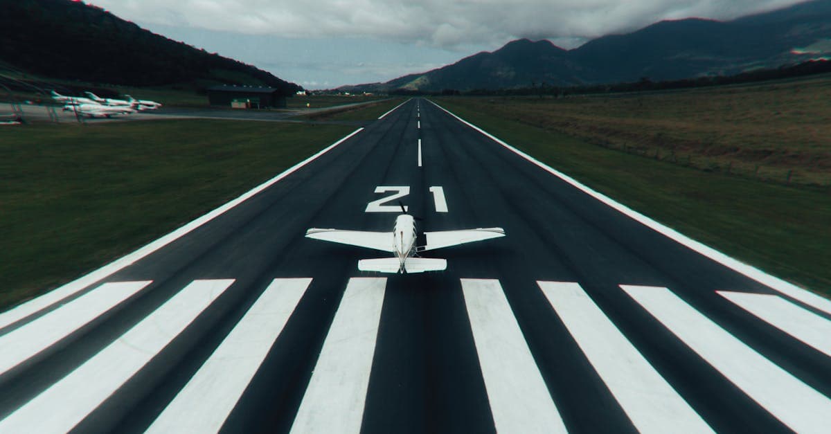 Small plane on a scenic mountain runway illustrating direct versus connecting New Zealand flight cost comparisons